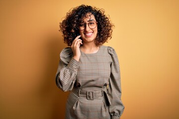 Sticker - Beautiful arab businesswoman wearing glasses having conversation talking on smartphone with a happy face standing and smiling with a confident smile showing teeth