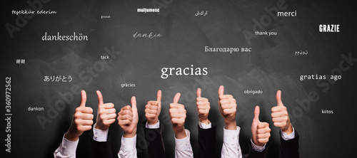 many thumbs up and blackboard with message THANK YOU in different languages