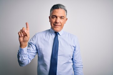 Canvas Print - Middle age handsome grey-haired business man wearing elegant shirt and tie pointing finger up with successful idea. Exited and happy. Number one.