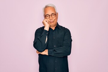 Wall Mural - Middle age senior grey-haired handsome man wearing glasses and elegant shirt thinking looking tired and bored with depression problems with crossed arms.