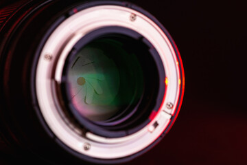 Wall Mural - Close up of the camera lens with the back side of the bayonet with red light  on a black background. Optics.