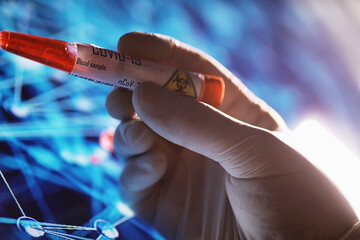 Test tube with patient blood for testing. Analysis for the virus. Coronavirus pandemic laboratory studies. Vaccine development.