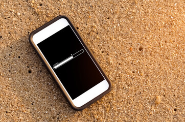 Smart phone with loading bar icon on tropical sand beach texture background.