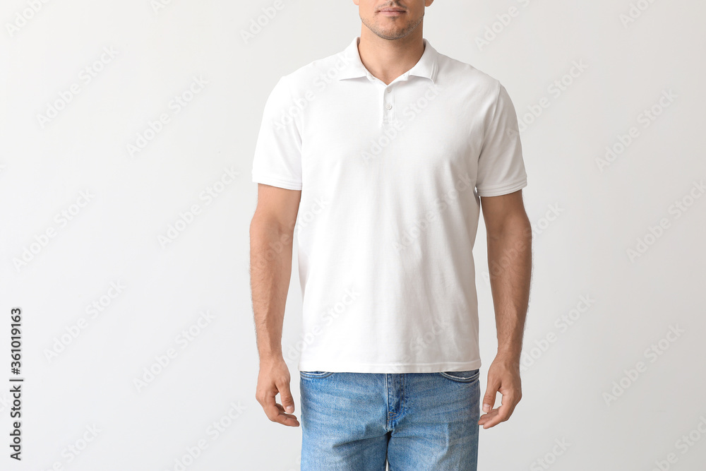 Young man in stylish t-shirt on light background - obrazy, fototapety, plakaty 