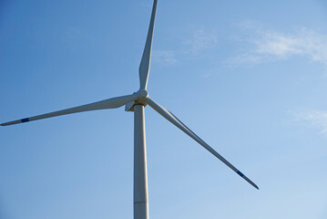 Wind turbine against blue sky. Wind power energy concept