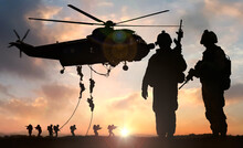 Military Commando Special Operation Helicopter Drops In Silhouette At Dusk