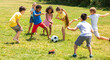© JackF - Company of glad children playing football on the playground