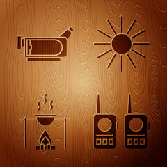 Canvas Print - Set Walkie talkie, Cinema camera, Campfire and pot and Sun on wooden background. Vector.