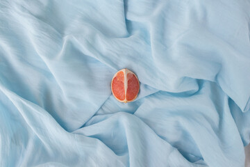 Blue installation - still life for blogger as blue background, modern art. Abstract with grapefruit and blue cloth