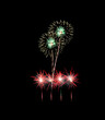 © boonsom - Green and red fireworks sparkling on night sky