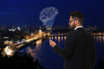 Poster - Young man using smartphone with virtual image of brain and night cityscape on background. Machine learning concept