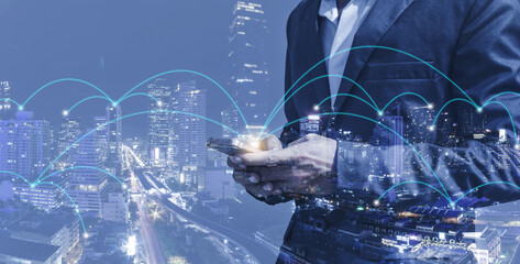 double exposure business man using smartphone with city background 5G wireless global internet web network connectivity technology digital wifi connect futuristic concept.