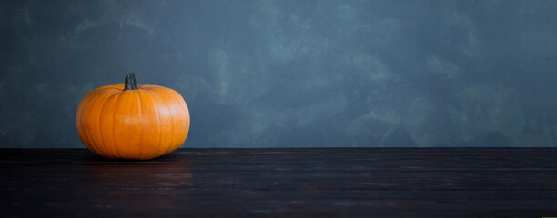 Wall Mural - orange pumpkins on dark wooden table