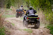 Selective focus. Two riders on ATVs ride on a dirt road. The concept of outdoor activities and extreme sports.