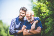 Leinwandbild Motiv Adult hipster son and old senior father stay for work at home, two generations have a beard talking together and relaxing with smile, happy enjoy living to isolation quarantine at home, father's day