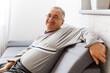 © Angelov - An elderly man sitting in a chair at his home, closeup with copy space