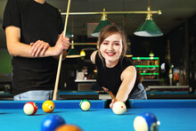 Pool Game. A Woman And A Man Are Playing Pool In The Club