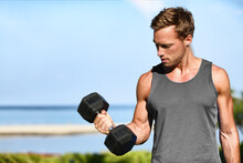 Bicep Curl Free Weights Training Fitness Man Outside Working Out Arms Lifting Dumbbells Doing Biceps Curls. Fit Man Arm Exercise Workout Exercising Arms With Dumbbell Weight At Outdoor Beach Gym.