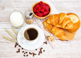 Fototapeta Mapy - Breakfast in the morning with black coffee cup with bread with Croissant and fruit on the wooden table.