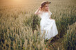 © Олег Кошевський - little girl with a straw hat. beautiful little girl with blond hair in a white dress in the background of a beautiful field. Girl with a bouquet of red poppies