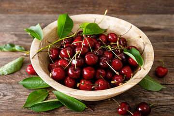 Poster - Sweet cherry with leaves in wooden bowl. Fresh ripe cherries. Cherry fruit