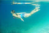 Fototapeta Łazienka - Woman swimming underwater
