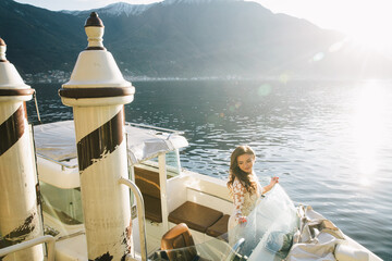 Wall Mural - Villa Balbianello wedding photoshoot beautiful couple bride and groom long veil and white dress on mountains background lake Como Italy ceremony luxury beautiful sunny day