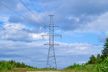 Power pole with wires against the blue sky. The correct form of metal construction