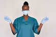 © insta_photos - Tired stressed female african american scrub frontline nurse wear face mask blue uniform meditating on grey background. Black woman doctor eyes closed breathing doing yoga feels stress relief concept.
