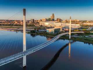 Bob Kerry Pedestrian Bridge spans the Missouri river with the Omaha Nebraska skyline in the background. 