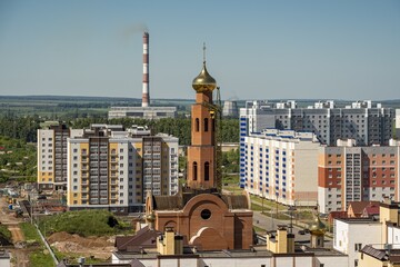 Poster - Horizontal shot of Russian Orthodox Church during construction surrounded by the apartment complexes