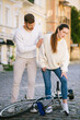 © zinkevych - Woman and man standing over lying bicycle on the road.