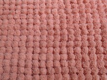 Closeup Shot Of A Light Red Fluffy Bumpy Patterned Carpet Texture