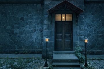 Old rustic classical stone house and brown vintage wooden door with wrought iron.