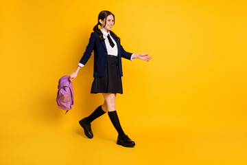 Full length body size view of her she nice attractive pretty cheerful cheery schoolgirl nerd going back to school carrying violet bag isolated bright vivid shine vibrant yellow color background