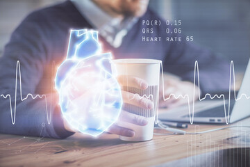 Heart drawing with man working on computer on background. Medical concept. Double exposure.