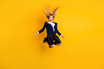 Poster - Full length body size profile side view small little cheerful schoolchild jumping having fun fooling after classes free time vacation rest isolated bright vivid shine vibrant yellow color background