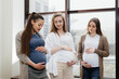 © Andrii - A group of young pregnant girls communicate in the prenatal class. Care and consultation of pregnant women