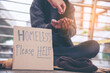 © aFotostock - Woman helping hands to homeless people poverty beggar man holding hands asking for money job and hoping help in helpless dirty city sitting on streets. Desperate Beggar in city concept.