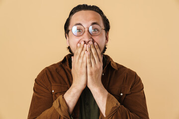 Image of young astonished man expressing surprise on camera