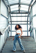 © iordani - young cute teenage african girl in industrial zone happy smiling having fun, big city lifestyle fashion people