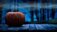One Spooky Halloween Pumpkin Blank Template On A Wooden Bench With A Misty Forest Night Background With Space For Product Placement.