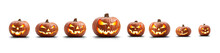 A Group Of Eight Lit Spooky Halloween Pumpkins, Jack O Lantern With Evil Face And Eyes Isolated Against A White Background.