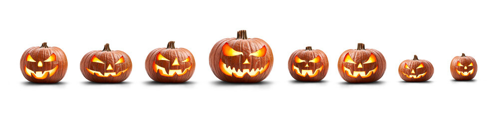 Wall Mural - a group of eight lit spooky halloween pumpkins, jack o lantern with evil face and eyes isolated agai