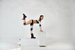 © константин константи - beautiful girl in a robot suit does gymnastic exercises on a white background