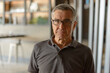 © Ranta Images - Handsome senior man with eyeglasses relaxing at home indoors