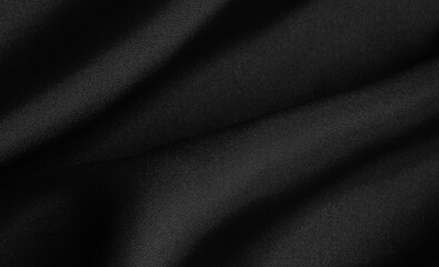 Black folded fabric. Liquid wavy background.
