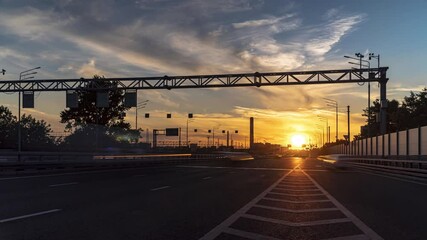 Wall Mural - Time lapse video of  traffic on urban thoroughfare along industrial zone at sunset