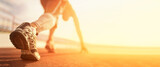 Fototapeta Zachód słońca - Athlete runner run on start at treadmill