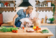 © GVS - Happy young couple in love dancing in kitchen at home and having fun